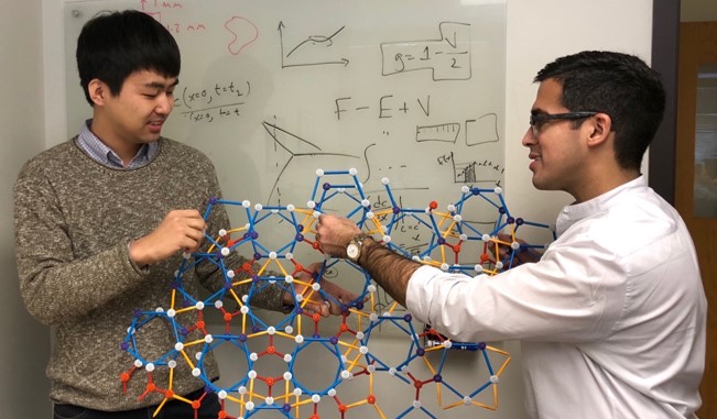 Shahani (right) and graduate student Insung Han (left) discuss cluster attachments on an atomic model of a 2D decagonal quasicrystal. Shahani (right) and graduate student Insung Han (left) discuss cluster attachments on an atomic model of a 2D decagonal quasicrystal.