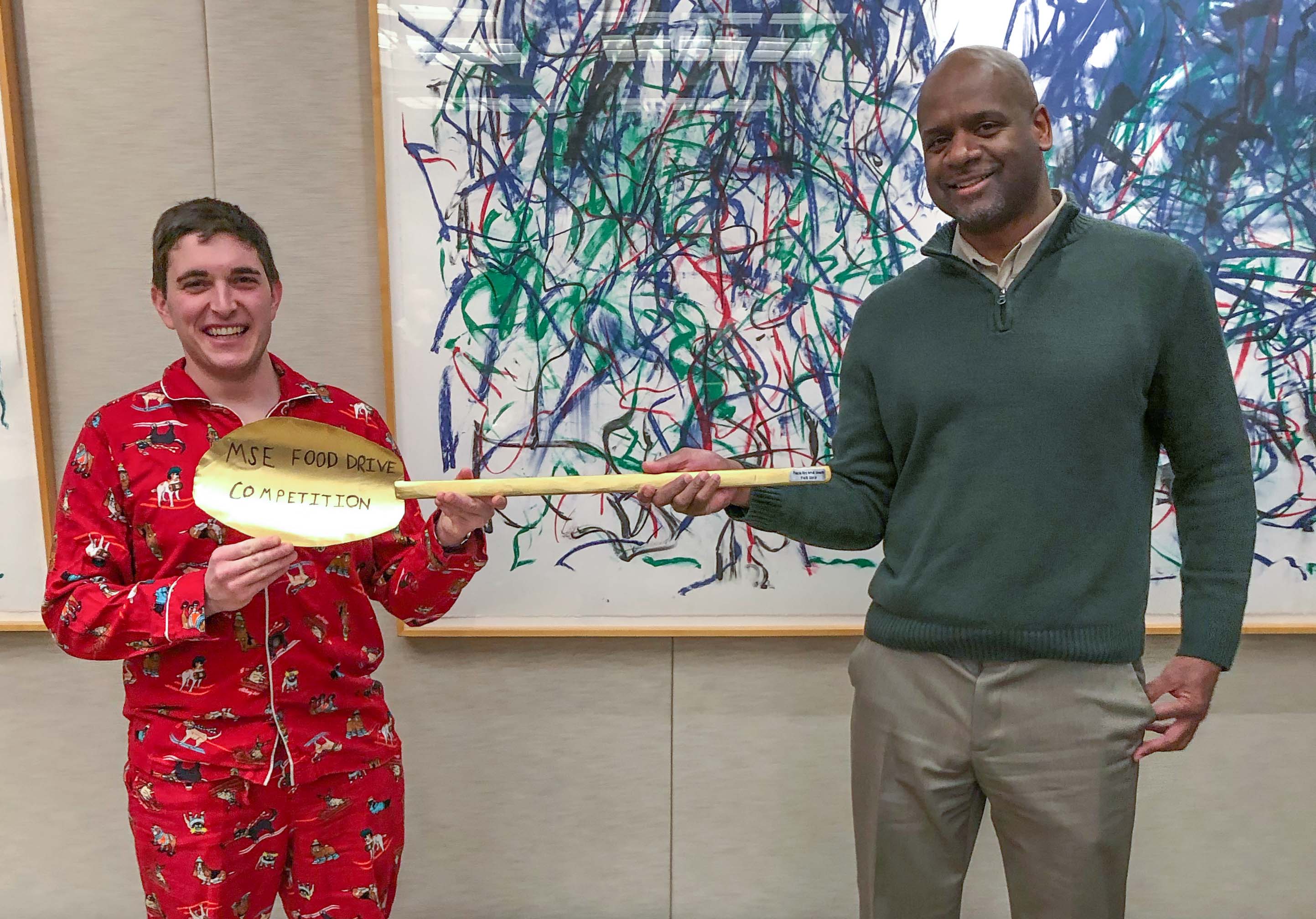 Todd Richardson (left) accepts the "Big Spoon" award on behalf of the winning faculty/staff team from Aaron Gladstein.