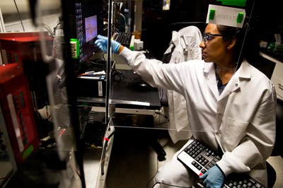 Stacy Ramcharan, a doctoral student in chemical engineering, uses a computerized system to layer polymer fibers, forming a scaffold for growing cells into artificial tissues. Photo: Joseph Xu, Michigan Engineering Communications & Marketing.